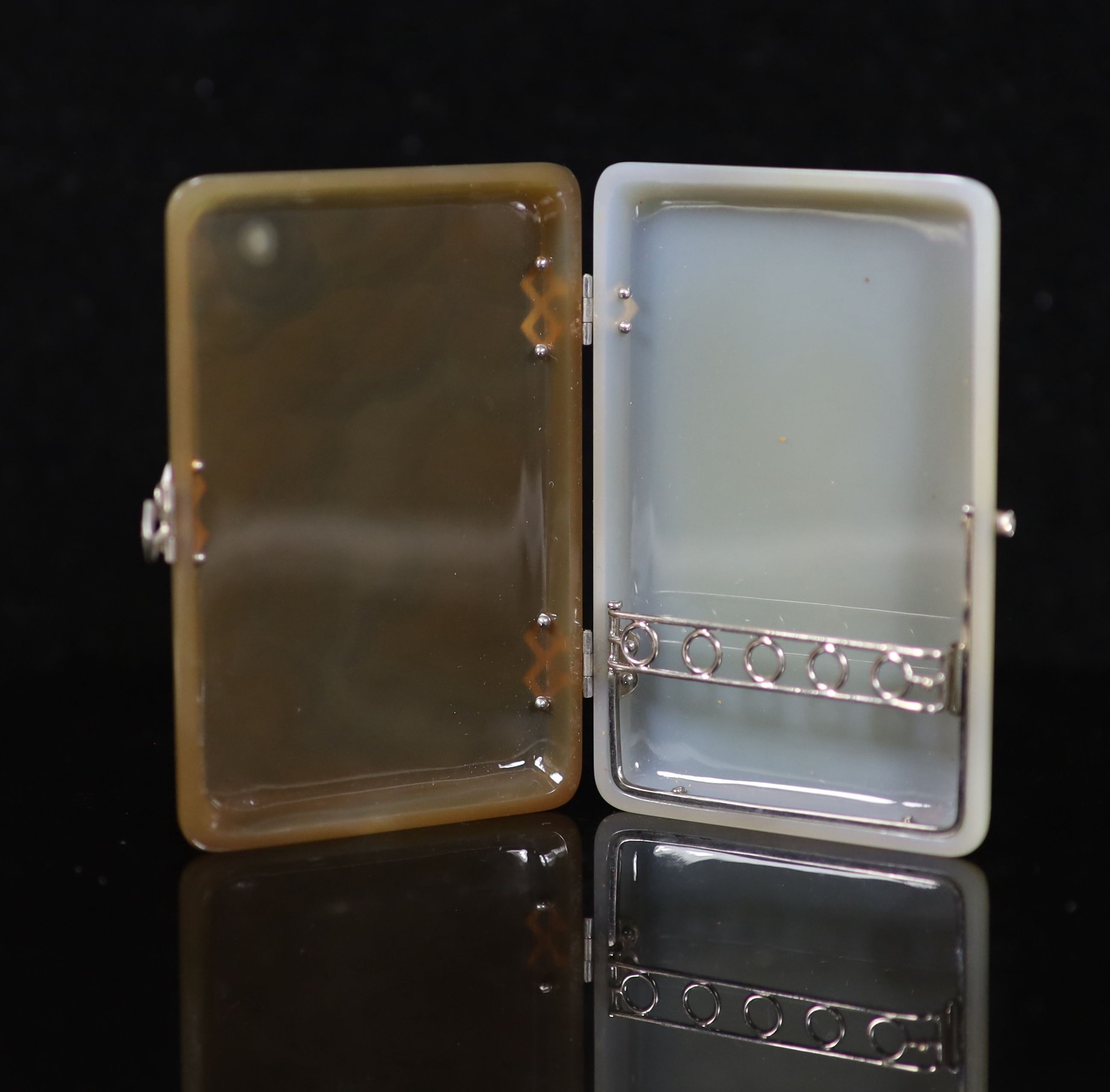 A 1920's French 18ct white gold, platinum and rose cut diamond set two colour agate rounded rectangular cigarette case, by Michel Ballada (Paris 1914-1922)